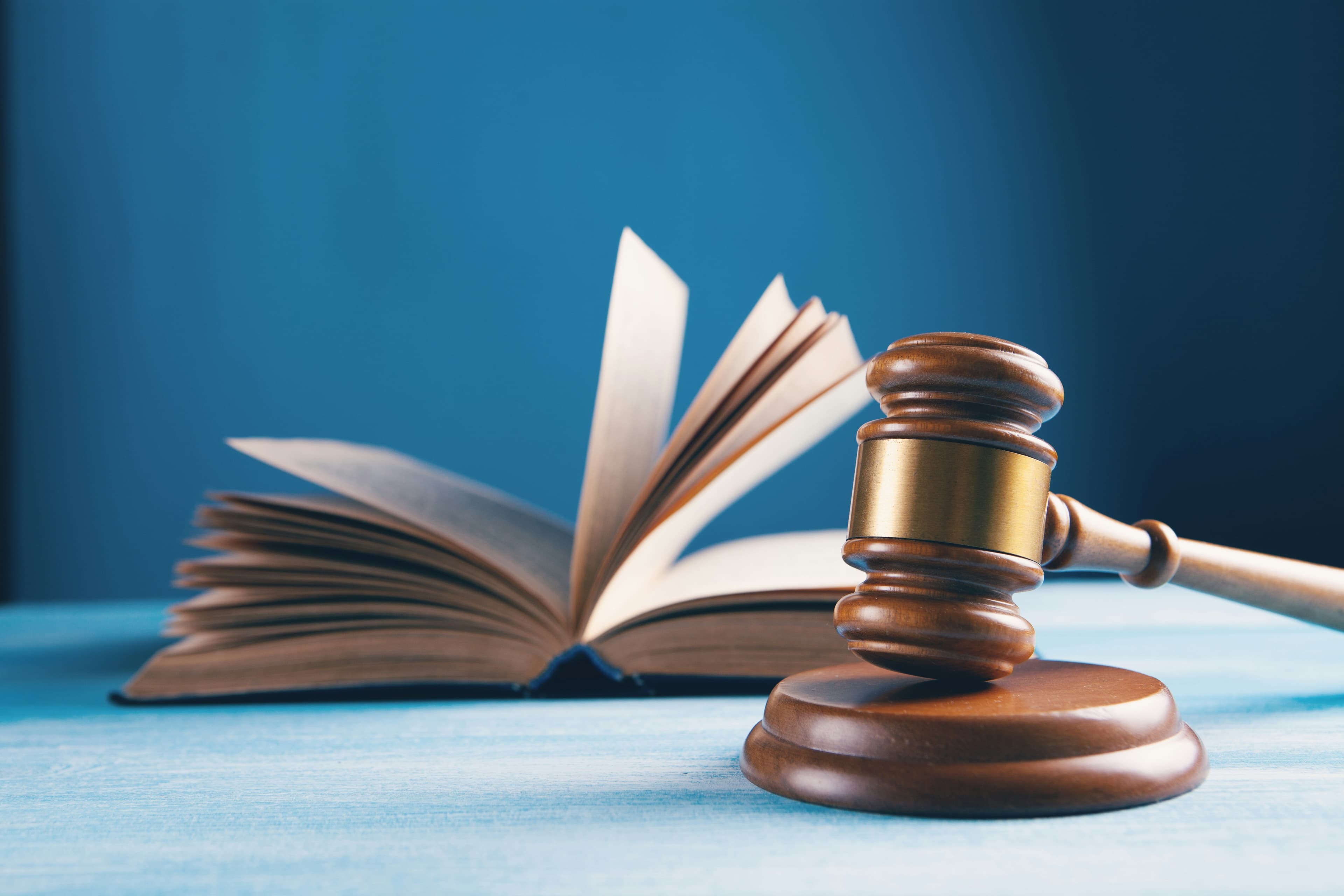 Judge's gavel resting beside an open law book