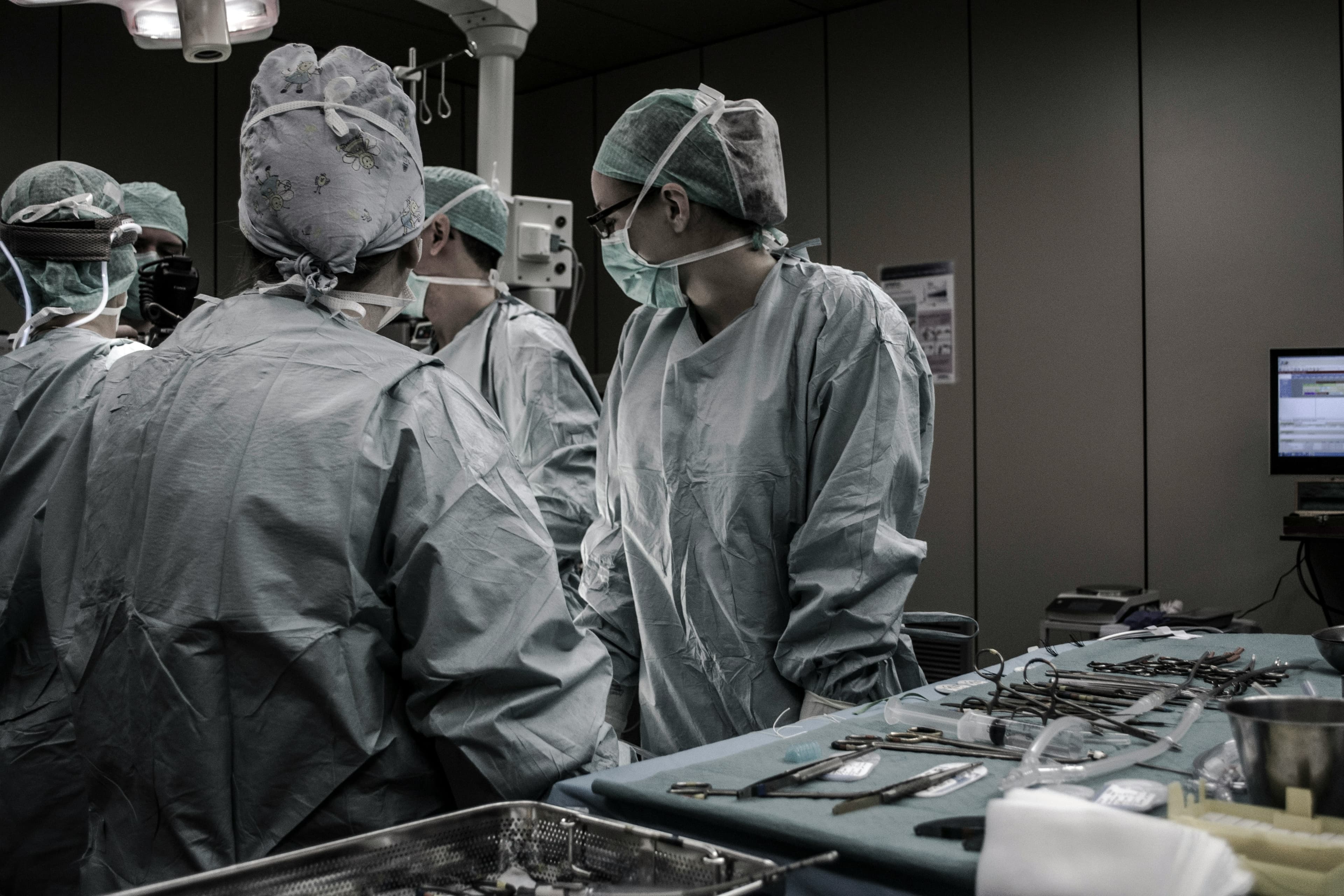 Surgical team in scrubs preparing for a procedure